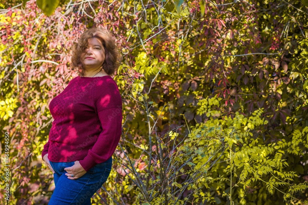 Plus size European or American mature woman at park, enjoy the life, walks. Life of people xl size, happy nice natural beauty woman. Concept of overweight