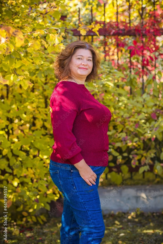 Plus size European or American mature woman at park, enjoy the life, walks. Life of people xl size, happy nice natural beauty woman. Concept of overweight Plus size European or American mature woman at park, enjoy the life, walks. Life of people xl size, happy nice natural beauty woman. Concept of overweight