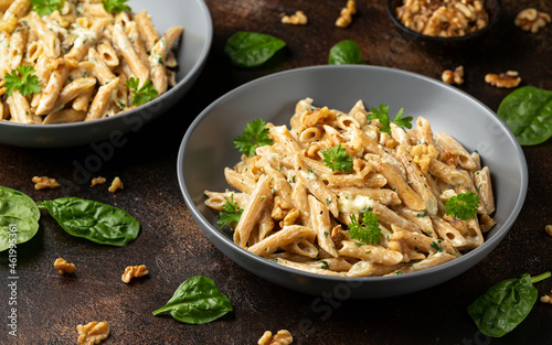 Whole Wheat Penne pasta with gorgonzola cheese sauce, spinach and walnut. Healthy food. photo