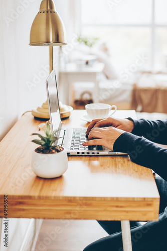 Businessman working on laptop at home office. Man watching online webinar. Remote work concept