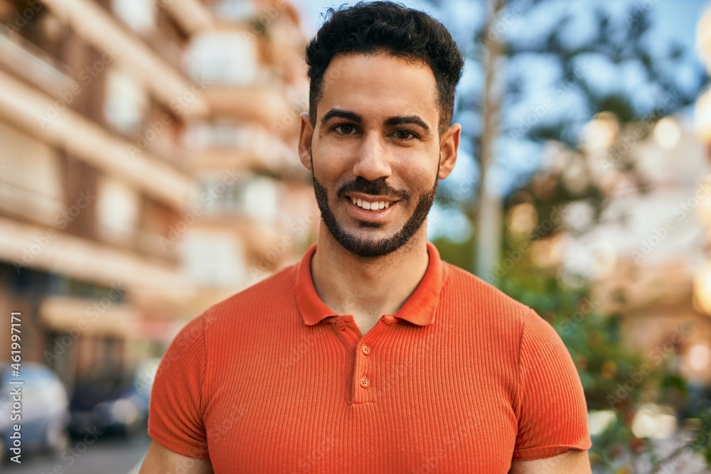 Young hispanic man smiling happy standing at the city. Young hispanic man smiling happy standing at the city.