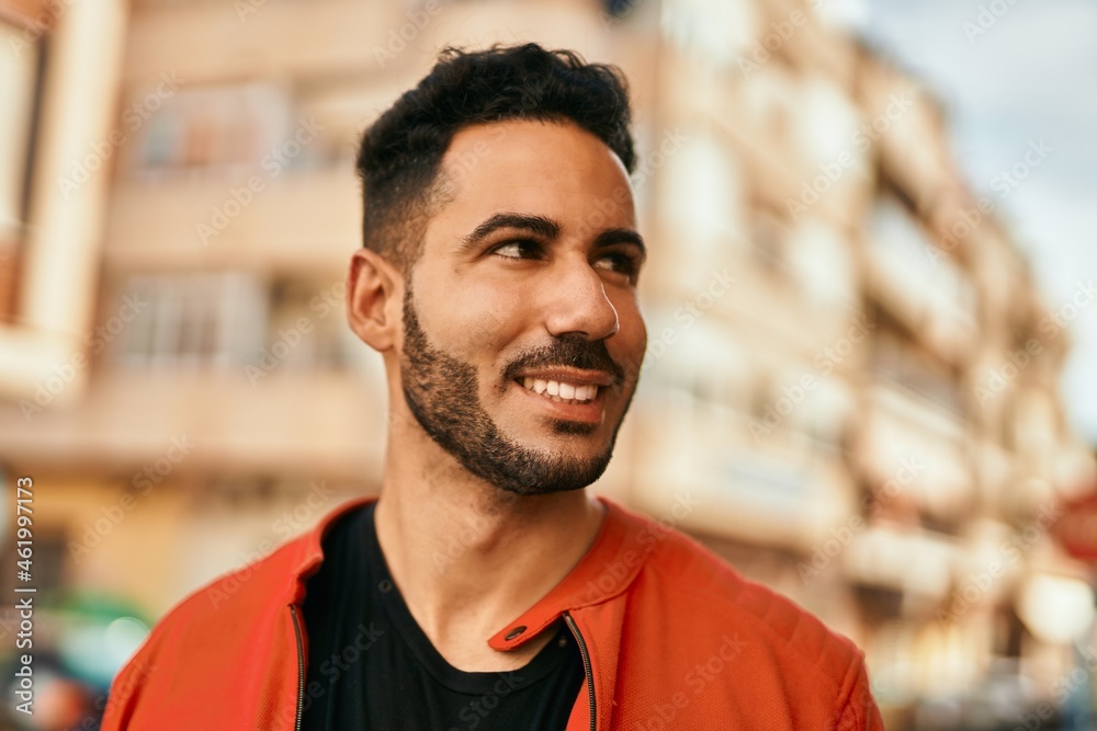 Young hispanic man smiling happy standing at the city. Young hispanic man smiling happy standing at the city.
