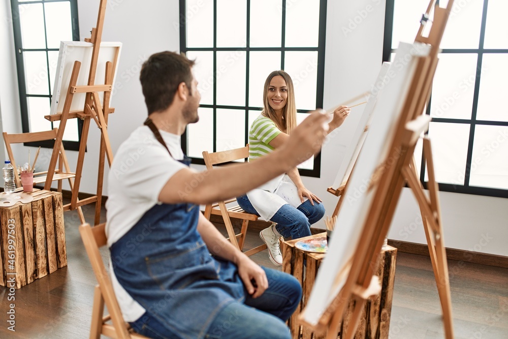 Two hispanic students smiling happy painting at art studio Two hispanic students smiling happy painting at art studio