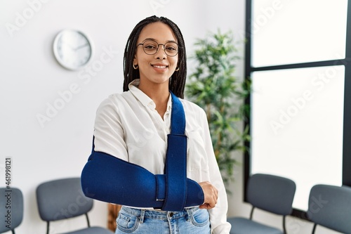 Young african american woman smiling confident injury on arm at clinic waiting room