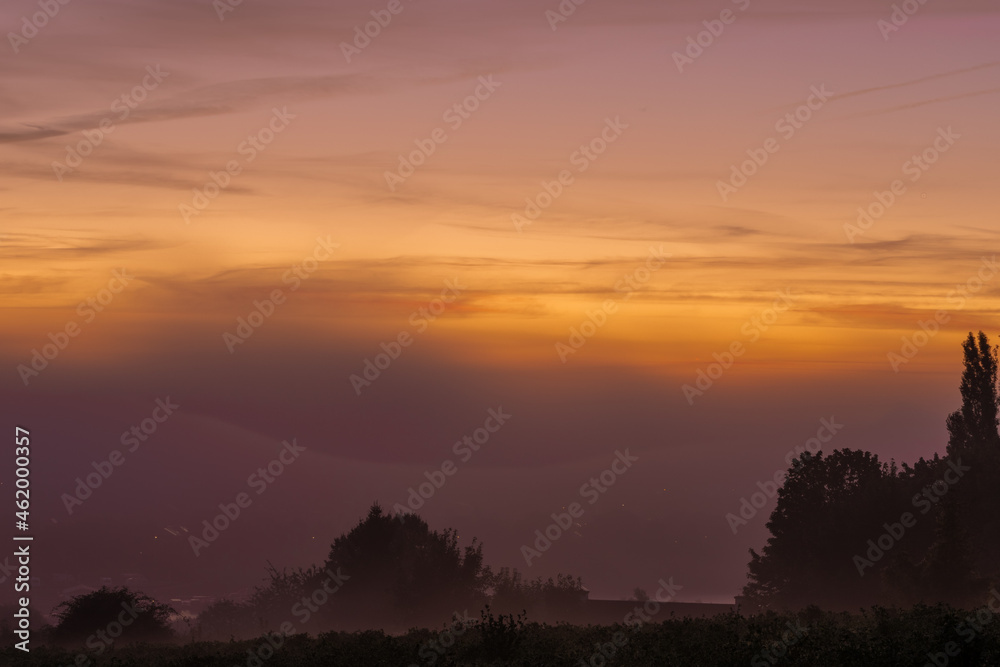 Early morning fog during a colourful sunrise in Maastricht, the Netherlands. These kind of mornings are often seen in the Autumn season