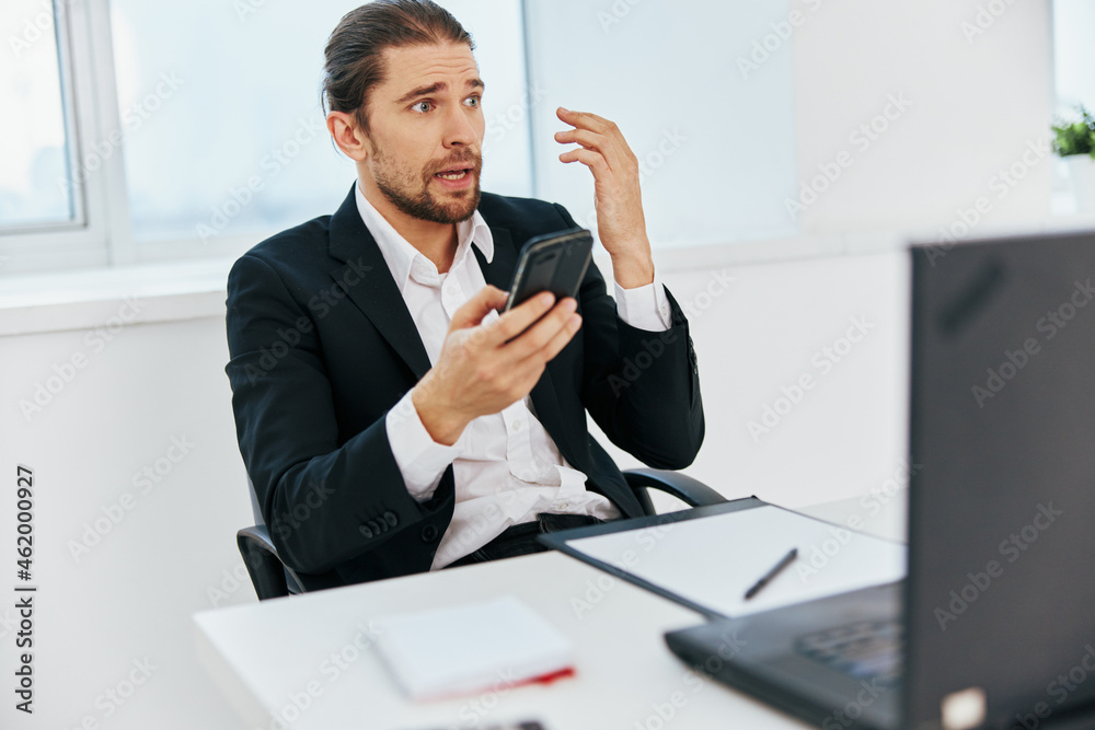 manager at the desk documents communication by phone technology manager at the desk documents communication by phone technology