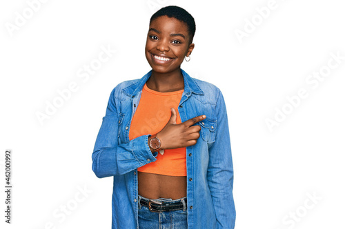 Young african american woman wearing casual clothes cheerful with a smile on face pointing with hand and finger up to the side with happy and natural expression