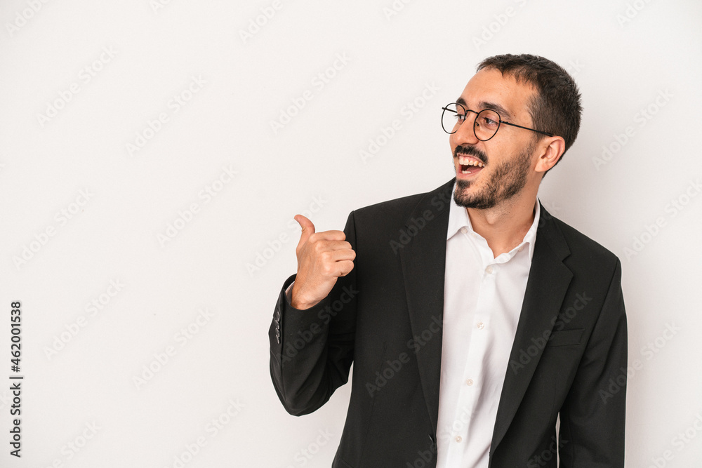 Young caucasian business man isolated on white background points with thumb finger away, laughing and carefree. Young caucasian business man isolated on white background points with thumb finger away, laughing and carefree.