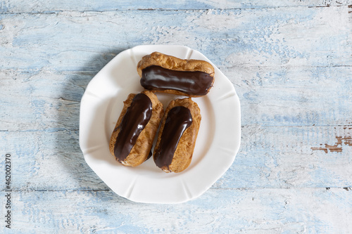 Traditional French dessert. Eclair with chocolate icing. Pastery concept photo