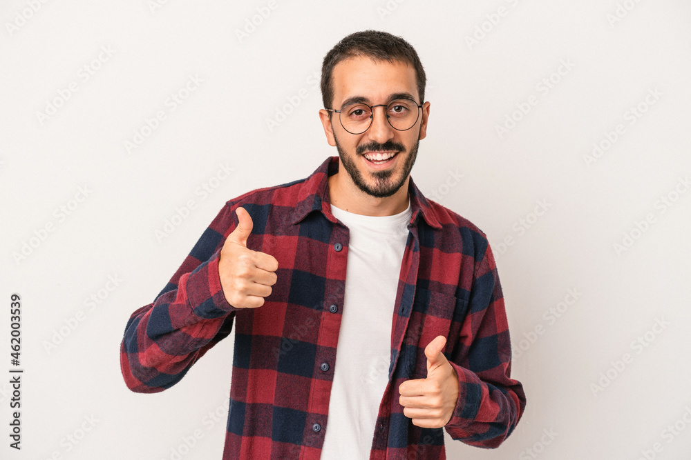 Young caucasian man isolated on white background raising both thumbs up, smiling and confident. Young caucasian man isolated on white background raising both thumbs up, smiling and confident.