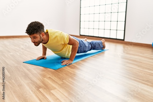 Young arab sporty man concentrate training abs exercise at sport center.