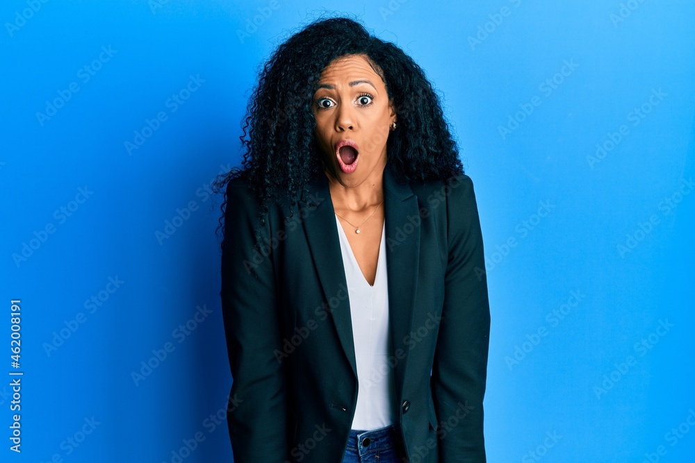 Middle age african american woman wearing business clothes afraid and shocked with surprise expression, fear and excited face.