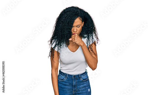 Middle age african american woman wearing casual white t shirt feeling unwell and coughing as symptom for cold or bronchitis. health care concept.