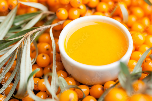 Sea buckthorn juice with fresh, ripe, berries. Healthy food. Close-up