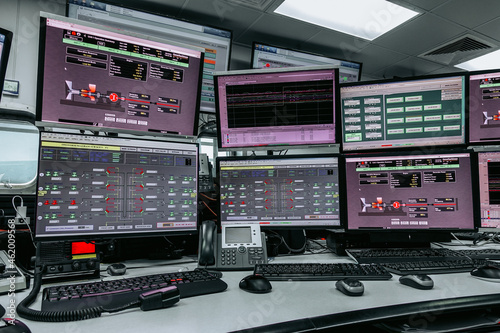 Fototapeta Naklejka Na Ścianę i Meble -  Process control In the System Monitoring Room or control room Work on many monitor. Facility is Full of Screens Showing plant process