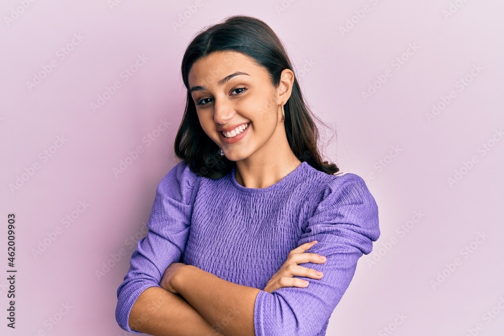 Young hispanic woman wearing casual clothes happy face smiling with crossed arms looking at the camera. positive person. Young hispanic woman wearing casual clothes happy face smiling with crossed arms looking at the camera. positive person.