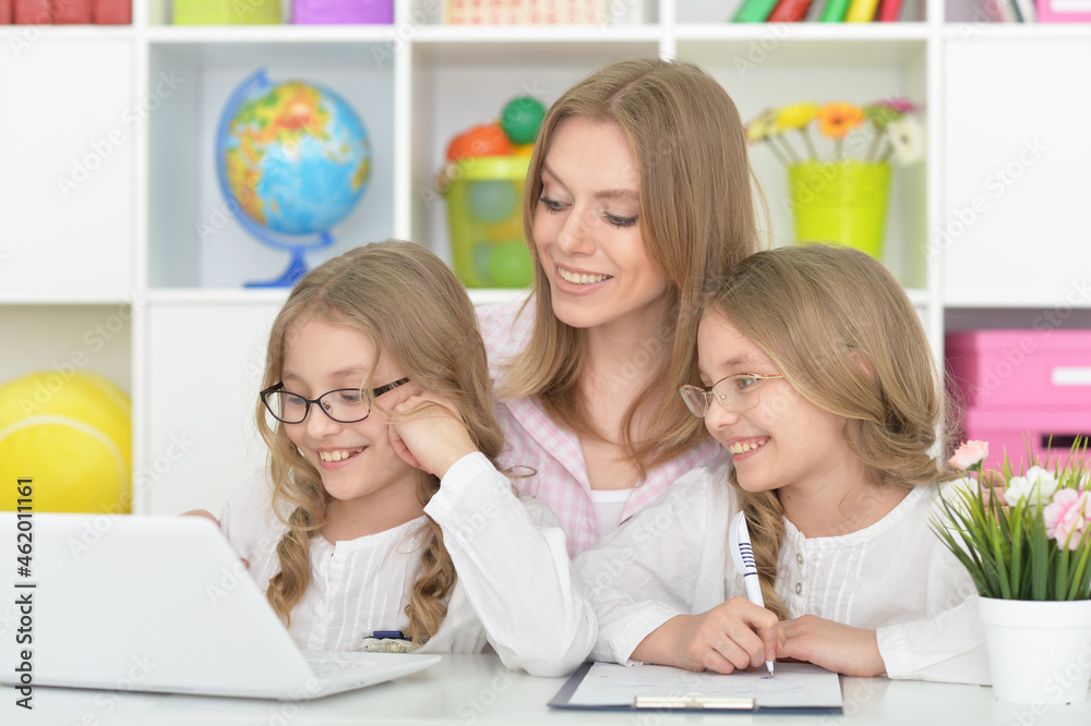 beautiful smiling girls using laptop with mother beautiful smiling girls using laptop with mother