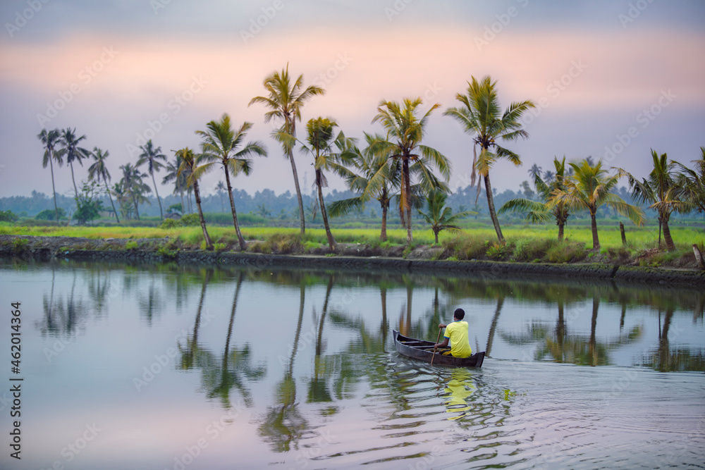 Kerala backwaters,Kadamakkudy Kerala - a man in a small boat, 