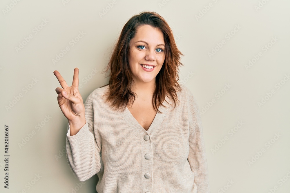 Young caucasian woman wearing casual clothes smiling looking to the camera showing fingers doing victory sign. number two. Young caucasian woman wearing casual clothes smiling looking to the camera showing fingers doing victory sign. number two.