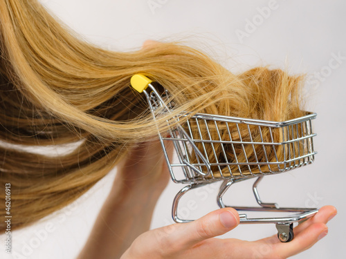 Girl with her long hair in shopping cart