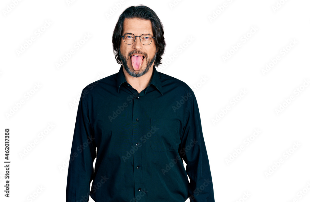 Middle age caucasian man wearing casual clothes and glasses sticking tongue out happy with funny expression. emotion concept.