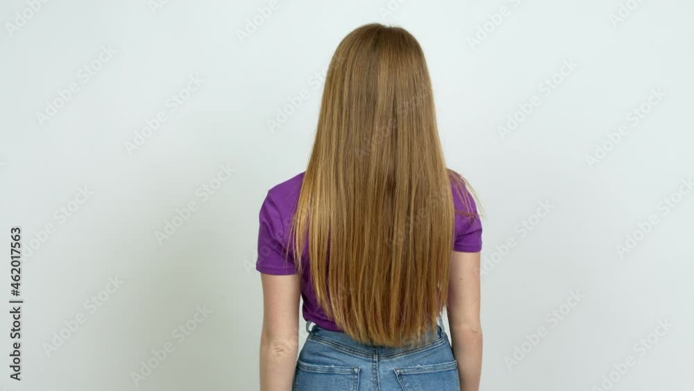 Teenager girl pointing back with the index finger over isolated background Teenager girl pointing back with the index finger over isolated background