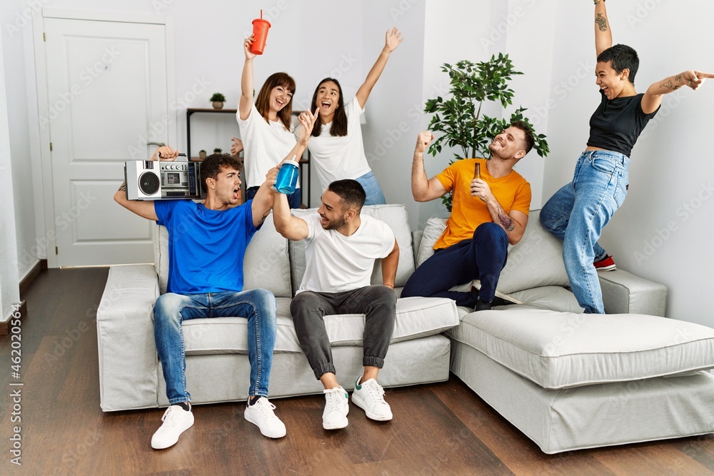 Group of young friends smiling happy and dancing at home. Group of young friends smiling happy and dancing at home.