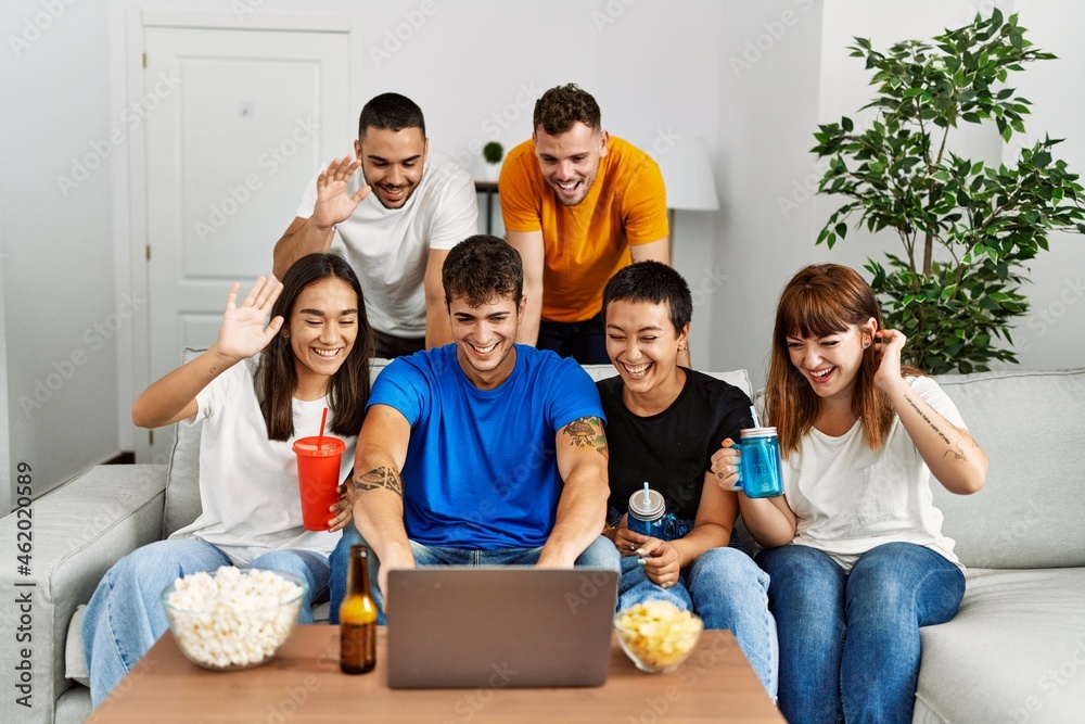 Group of young friends smiling happy having video call using laptop at home. Group of young friends smiling happy having video call using laptop at home.