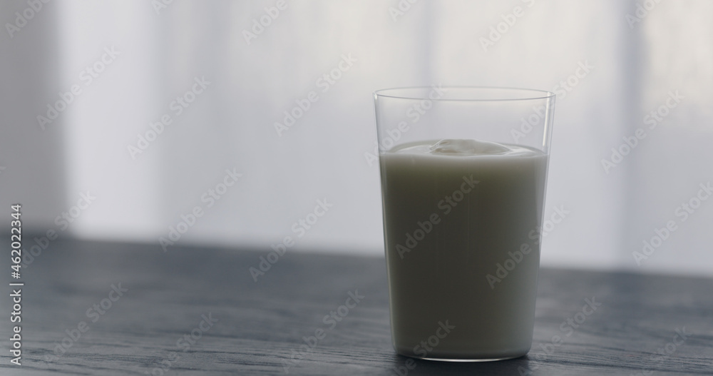 organic yogurt in tumbler glass on black wood table with copy space organic yogurt in tumbler glass on black wood table with copy space