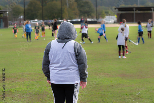 The goalie is all bundled up on this very chilly October day. Girls field hockey on a cold Autumn afternoon.