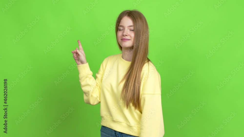 Teenager girl doing NO gesture over isolated background. Green screen chroma key Teenager girl doing NO gesture over isolated background. Green screen chroma key