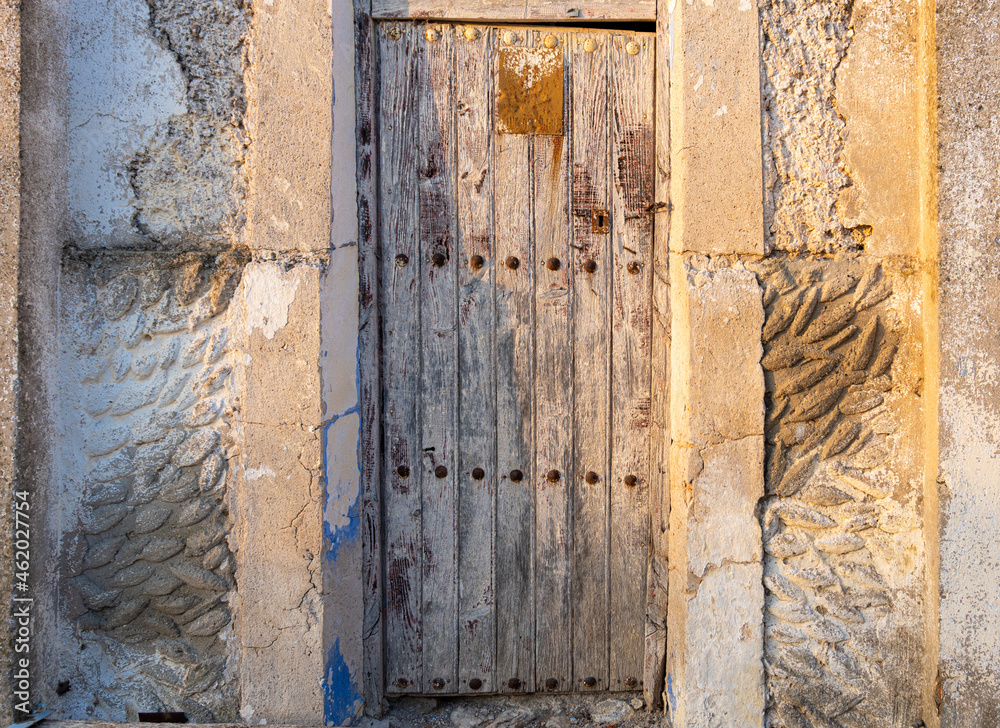 Aged and rustic wooden door in an abandoned house. Aged and rustic wooden door in an abandoned house.