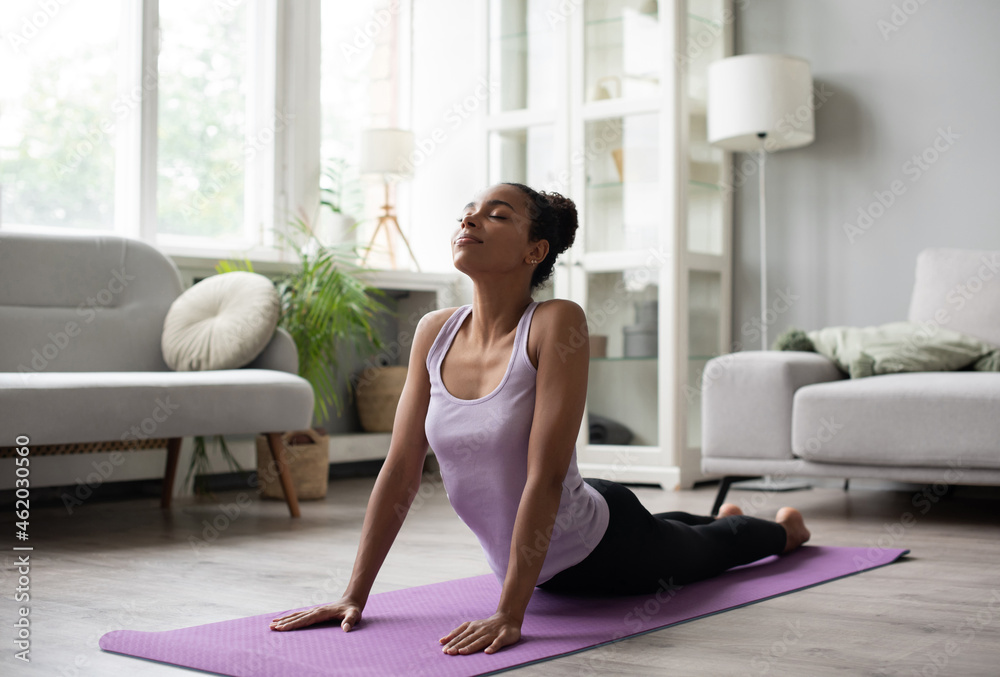 Young woman doing relaxation exercises and meditating at home. Sport, pilates, gymnastics, fitness, meditation, relaxation, training, yoga, healthy lifestyle concept Young woman doing relaxation exercises and meditating at home. Sport, pilates, gymnastics, fitness, meditation, relaxation, training, yoga, healthy lifestyle concept