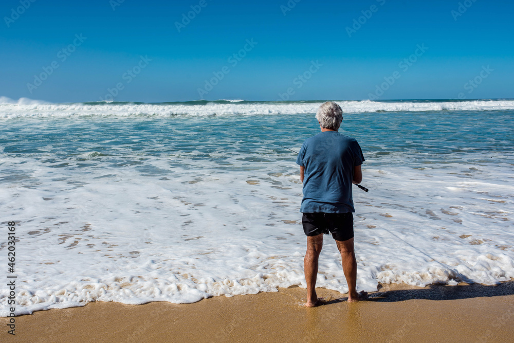 fisherman and his rod fishing by the ocean fisherman and his rod fishing by the ocean
