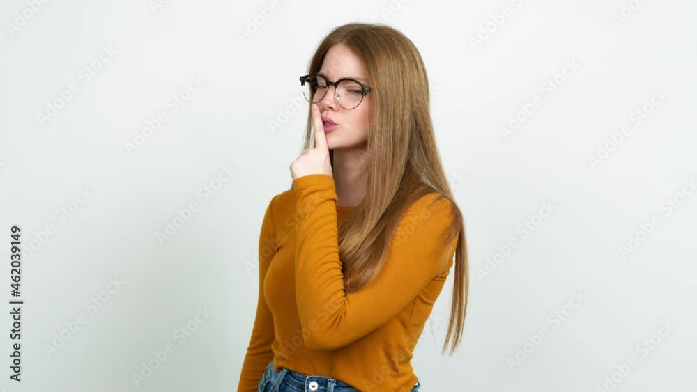 Teenager girl with glasses and doing silence gesture Teenager girl with glasses and doing silence gesture