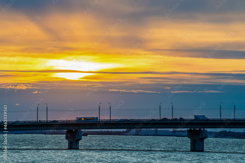 Obraz premium Transport moves across the bridge at sunset