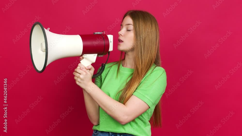 Teenager girl shouting through a megaphone over isolated background Teenager girl shouting through a megaphone over isolated background