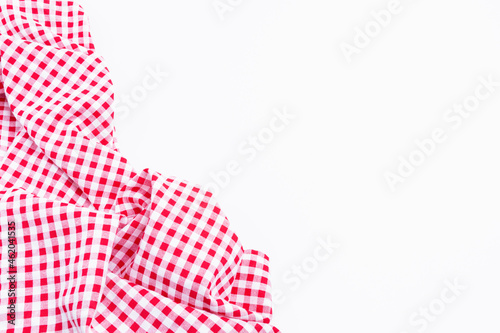 Red and white tablecloth texture picnic isolated on white background. Checkers fabric crumpled top view with copy space.