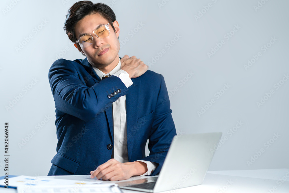 asian businessman wear formal suit sitting in office feeling body pain by office syndrome various symptoms including the inflammation of neck, shoulder and back muscles studio shot white background asian businessman wear formal suit sitting in office feeling body pain by office syndrome various symptoms including the inflammation of neck, shoulder and back muscles studio shot white background