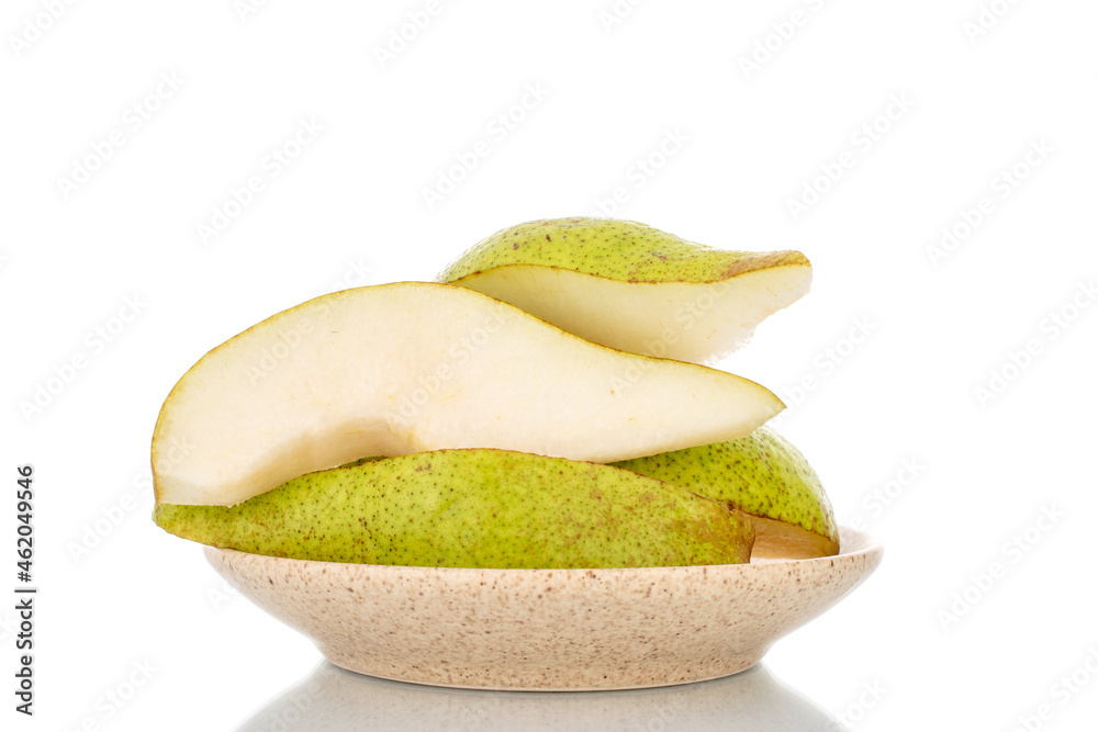 Several sweet pear slices on a ceramic dish, close-up, isolated on white.