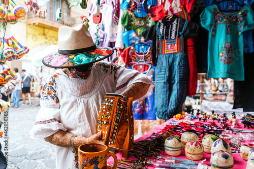 unrecognizable latina grandma buying souvenirs