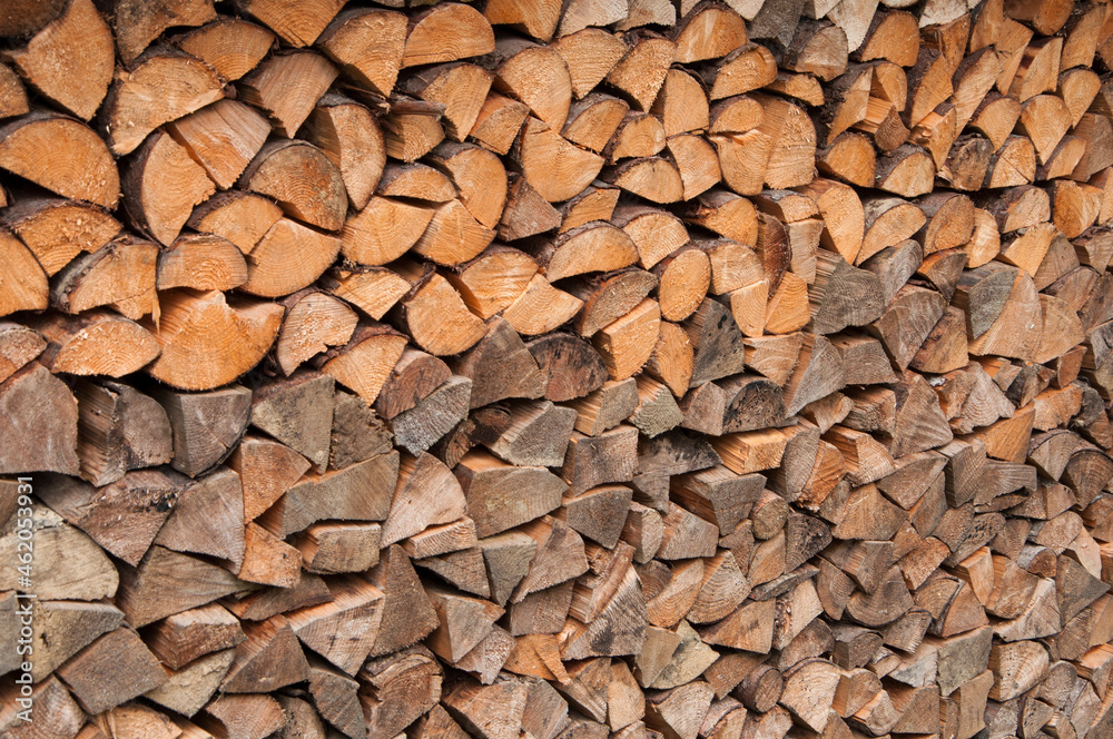 stacked chopped firewood. timber bars at a sawmill. wood background. stacked chopped firewood. timber bars at a sawmill. wood background.