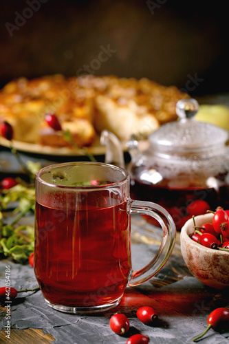Rose hip berries herbal tea in glass teapot