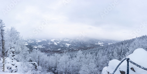 Panoramic view of winter snowy landscape in Jeseniky mountains from viewpoint of Medvedi Kamen photo