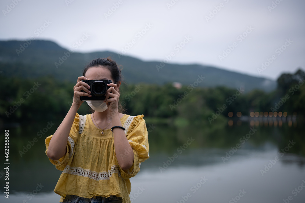Series photo of Young women wearing surgical protection mask playing with camera in the evening , freedom , actvity and recreation concept