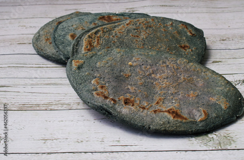 Tlacoyo on a white napkin with blue edges, on a wooden board photo