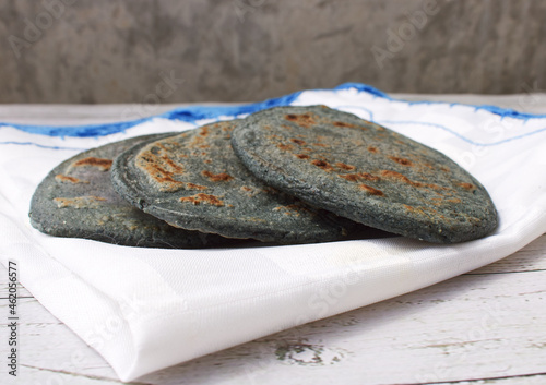 Tlacoyo on a white napkin with blue edges, on a wooden board photo