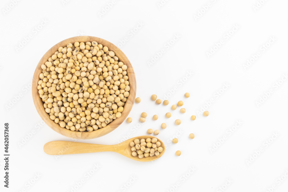 Soybean in wooden bowl and spoon on white background with free copy space Soybean in wooden bowl and spoon on white background with free copy space