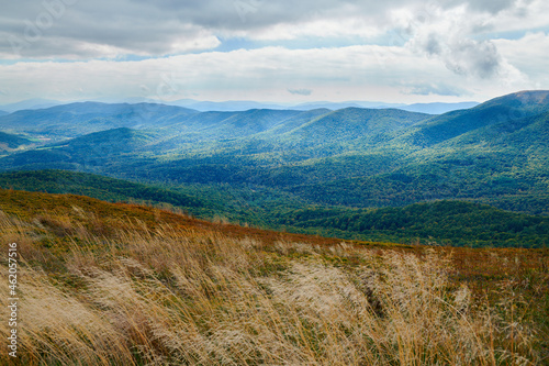 Bieszczady jesienią. Turyści na górskich szlakach. Połoniny. Ciemne chmury. Korory jesieni.