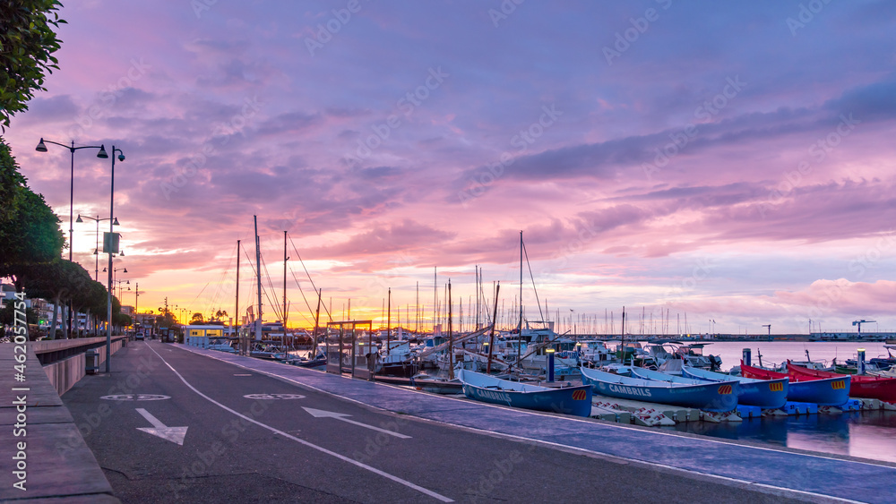 View of Sunrise Over Fishing Boats With Colofull Clouds in the Sky